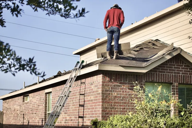 Professional roofer working on a residential roof in Gwynedd Pointe